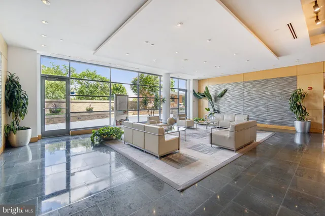a living room with fireplace furniture and a large window