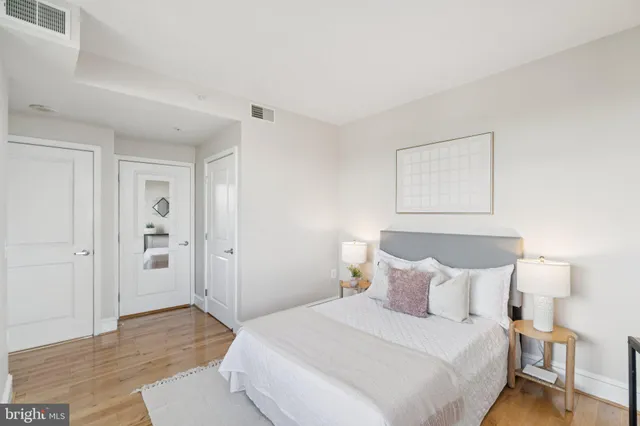 a bedroom with a bed and a painting