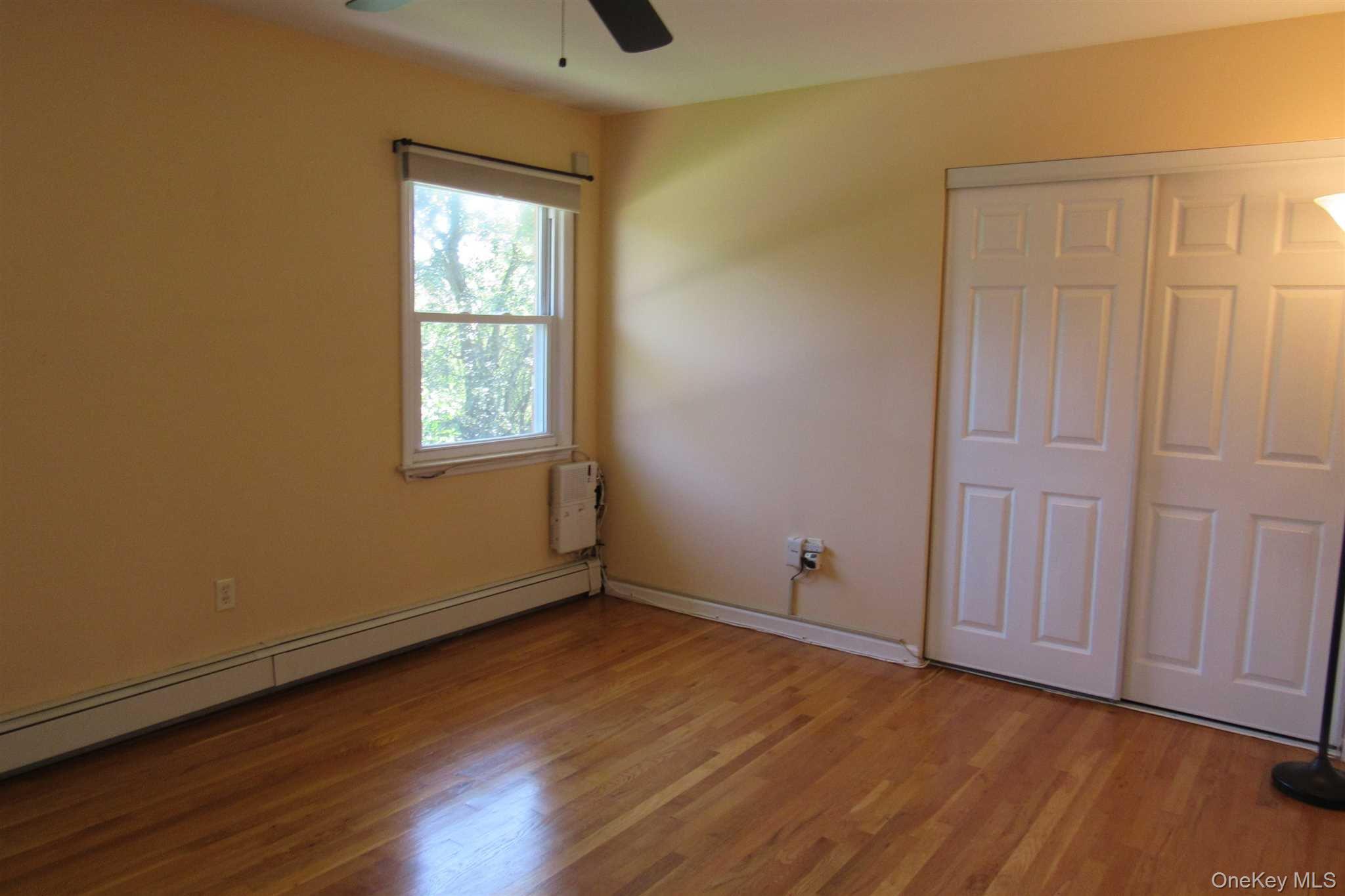 34 Alpine Drive, Unit A Wappingers Falls, NY 12590 - Photo 16 of 20 an empty room with wooden floor and windows