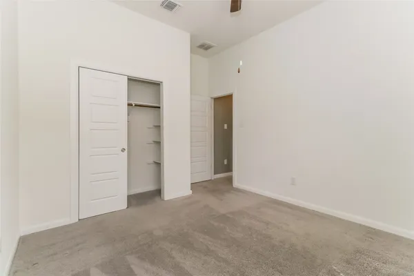 an empty room with windows and closet