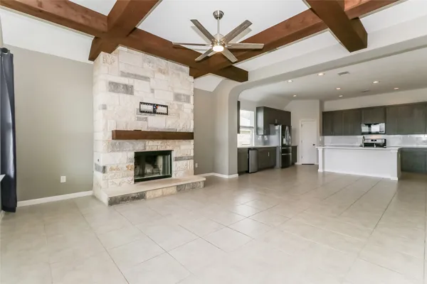 a view of a livingroom with a fireplace and a ceiling fan