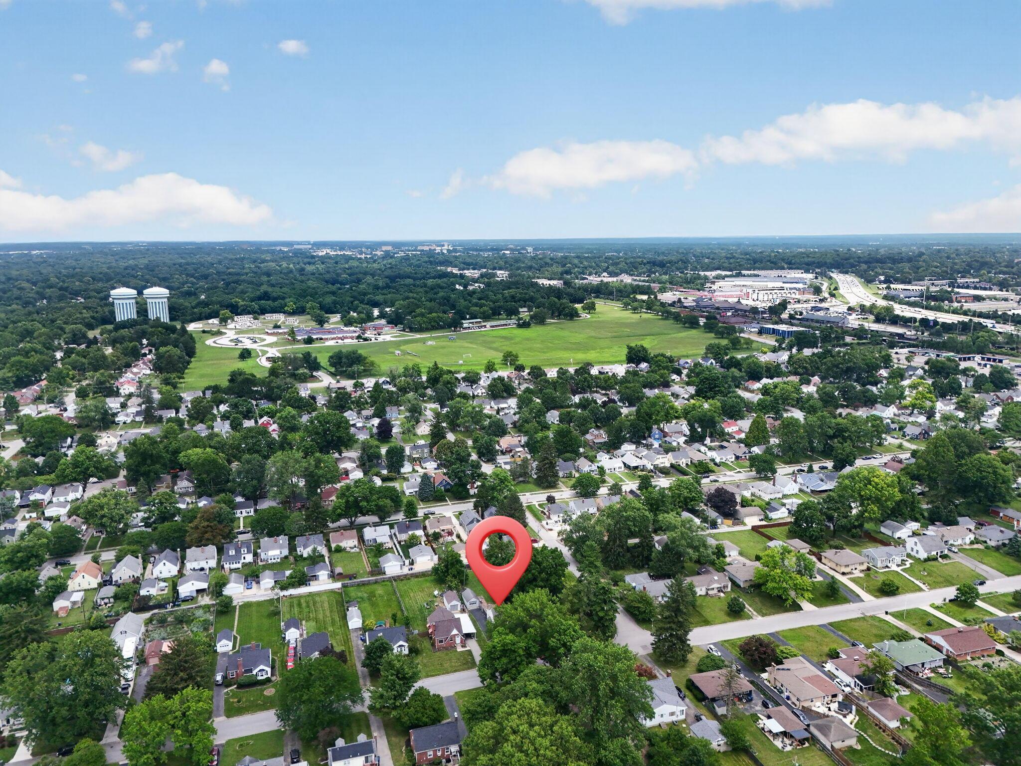 492 Wetmore Road Columbus, OH 43214 - Photo 48 of 55 Aerial perspective showcasing a residential neighborhood with mature trees and a distant commercial corridor