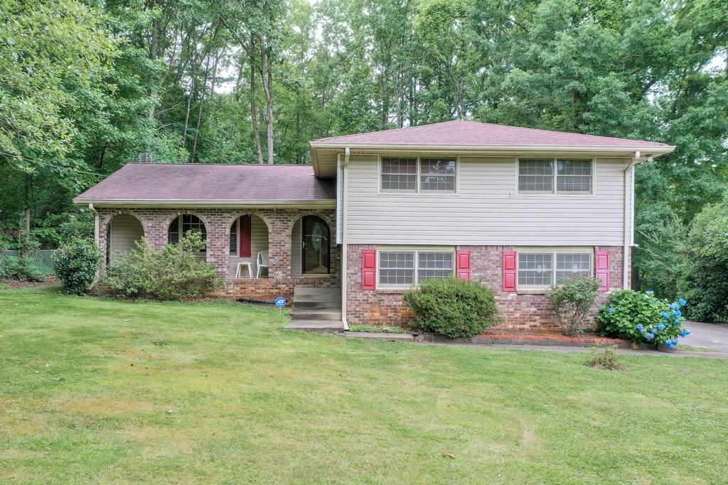 4960 Westridge Lane Powder Springs, GA 30127 - Photo 1 of 1 a front view of a house with garden