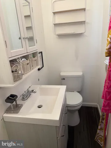 a bathroom with a sink a toilet and mirror