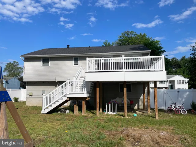 a view of a house with a patio and a yard