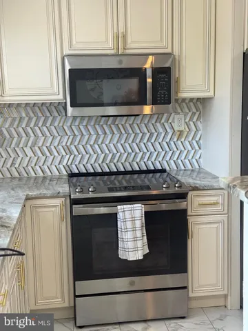 a stove top oven sitting inside of a kitchen