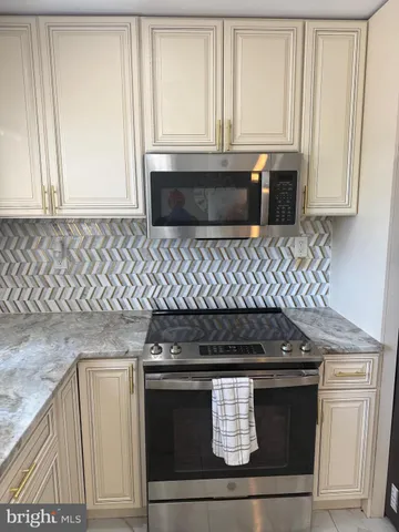 a stove top oven sitting inside of a kitchen
