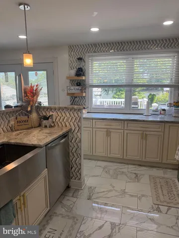 a kitchen with stainless steel appliances granite countertop a sink and cabinets