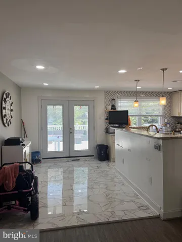 a living room with furniture and a open kitchen