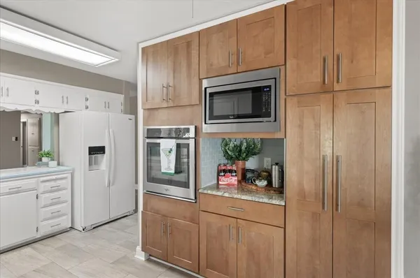 a kitchen with stainless steel appliances a refrigerator sink and cabinets