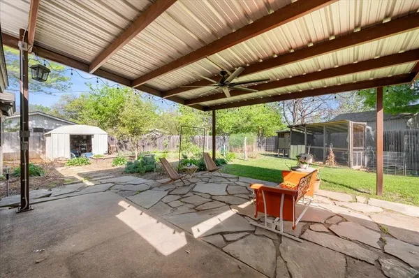 a view of a patio with a table chairs and a backyard