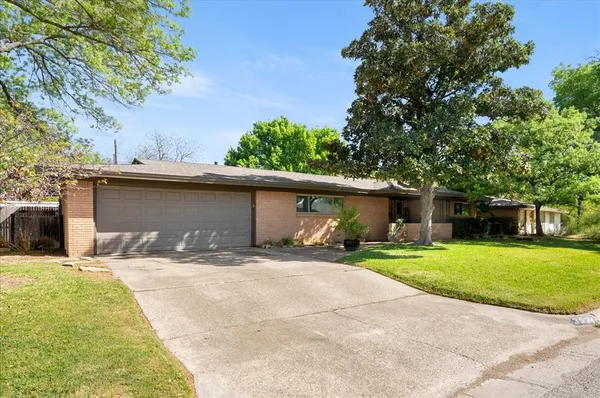a wooden house with trees in the background