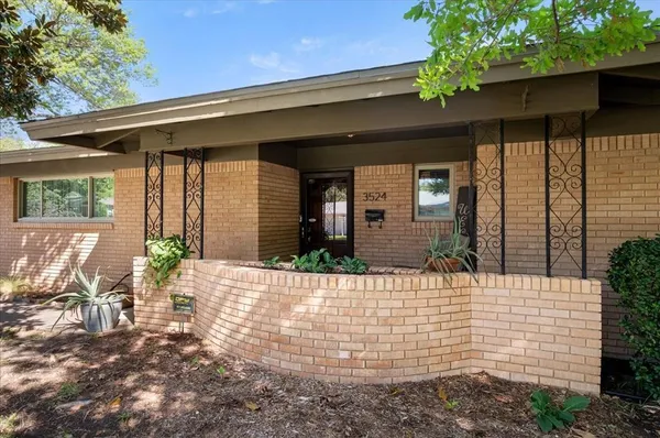 a view of house with patio outdoor seating