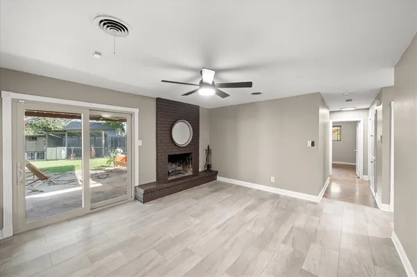 a view of a livingroom with wooden floor and a ceiling fan