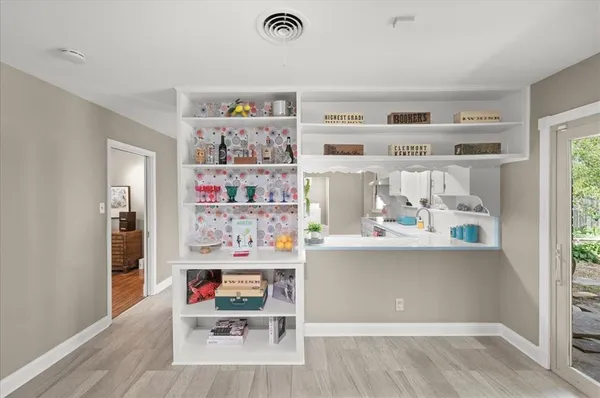 a living room with furniture and a bookshelf