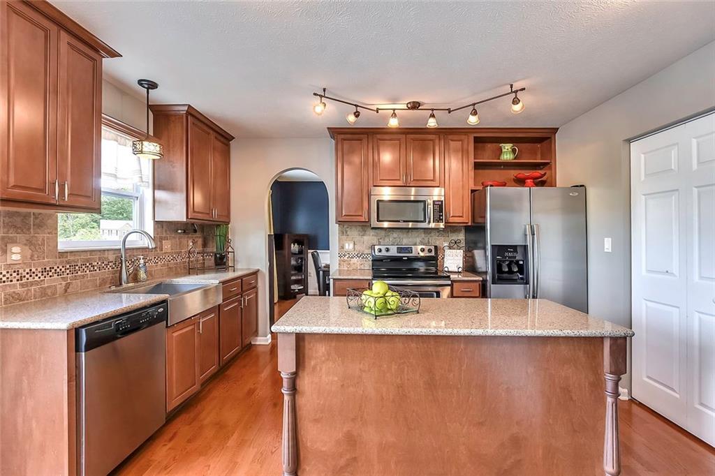 503 Walnut Drive McKees Rocks, PA 15136 - Photo 3 of 25 This gourmet kitchen offers stainless steel appliances, granite counter tops, decorative center island, maple cabinetry, tile backsplash, and large stainless farmhouse sink.