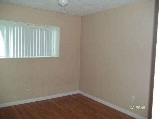 305 West Perdew Avenue Ridgecrest, CA 93555 - Photo 8 of 9 a view of an empty room with wooden floor and a window