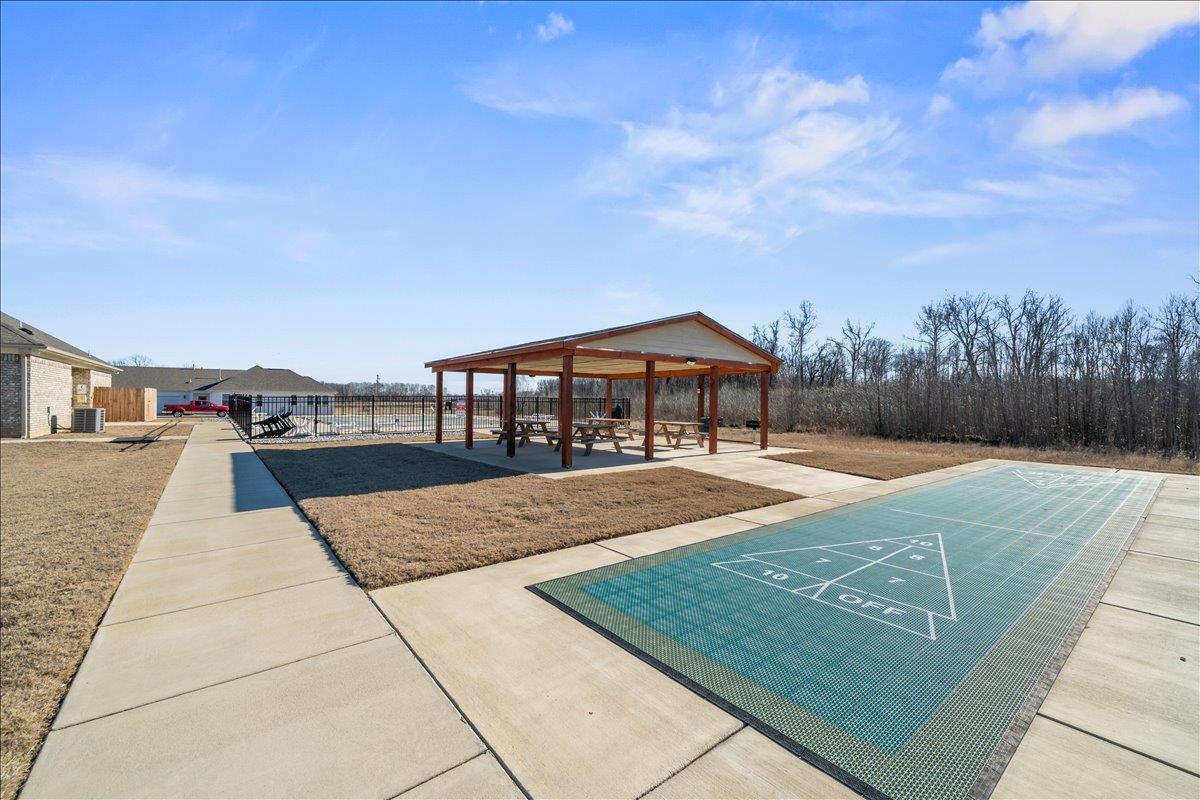 415 Abbey Road, Unit D Munford, TN 38058 - Photo 35 of 35 Outdoor recreation area featuring a shuffleboard court, covered pavilion with picnic tables, and concrete pathways