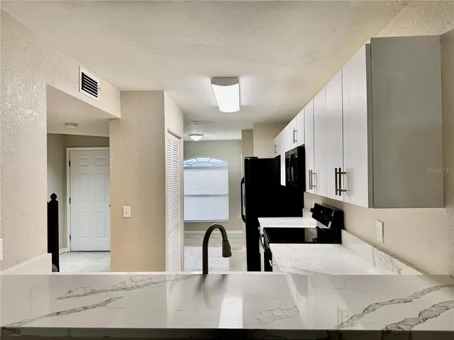 a view of a living room filled with furniture