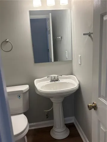 a bathroom with a sink toilet and a mirror