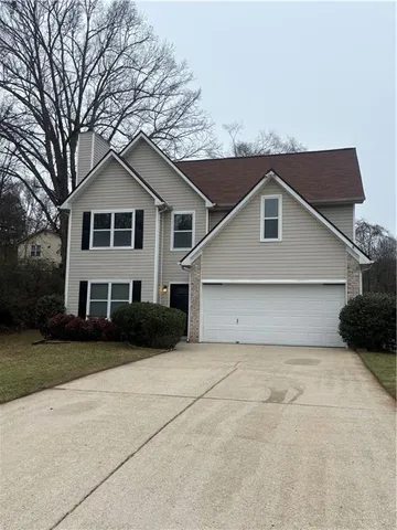 a front view of house with yard and trees