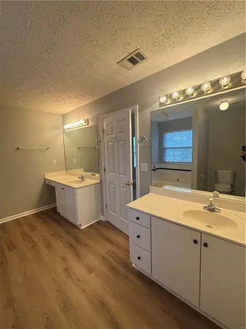 a bathroom with a sink double vanity and a mirror