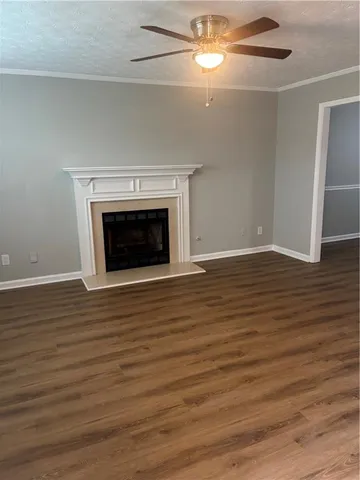 wooden floor fireplace and natural light in empty room