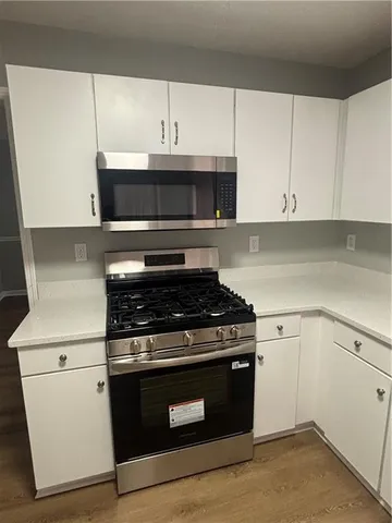 a kitchen with cabinets and appliances