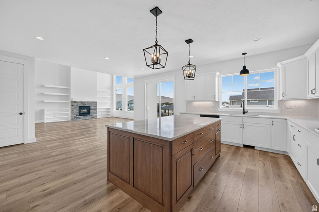 1002 West Temple Rim Lane Payson, UT 84651 - Photo 22 of 68 Spacious open-concept living area featuring a large kitchen island with a stone countertop, white shaker cabinetry, and wood-finish flooring