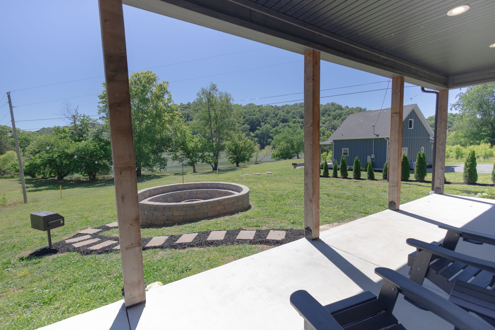 571 Bedford Lake Road Normandy, TN 37360 - Photo 47 of 96 a view of a patio with table and chairs potted plants with palm trees
