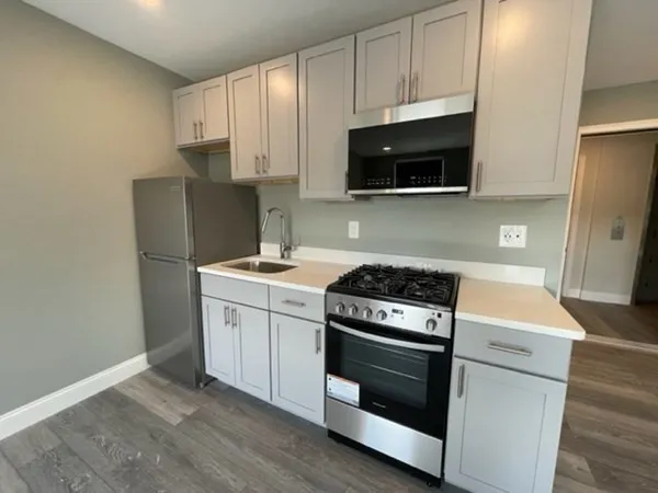 a kitchen with a stove and a microwave