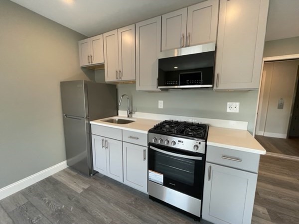 180 Shirley Avenue, Unit 210 Revere, MA 02151 - Photo 3 of 10 a kitchen with a stove and a microwave