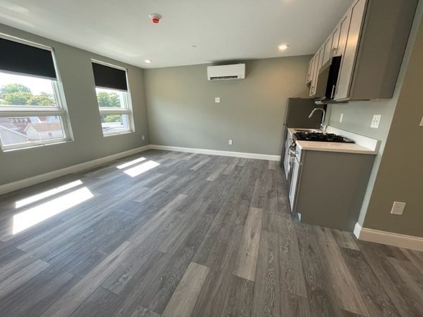180 Shirley Avenue, Unit 210 Revere, MA 02151 - Photo 6 of 10 a view of empty room with wooden floor and fan