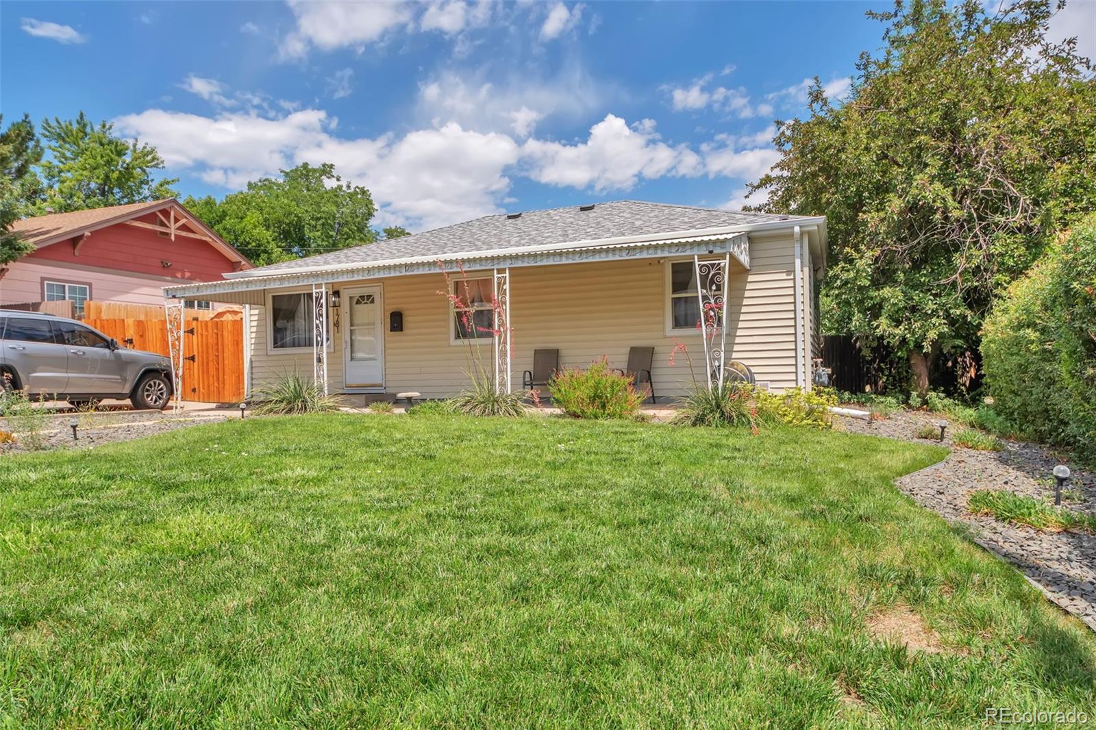 a view of a house with yard and a garden