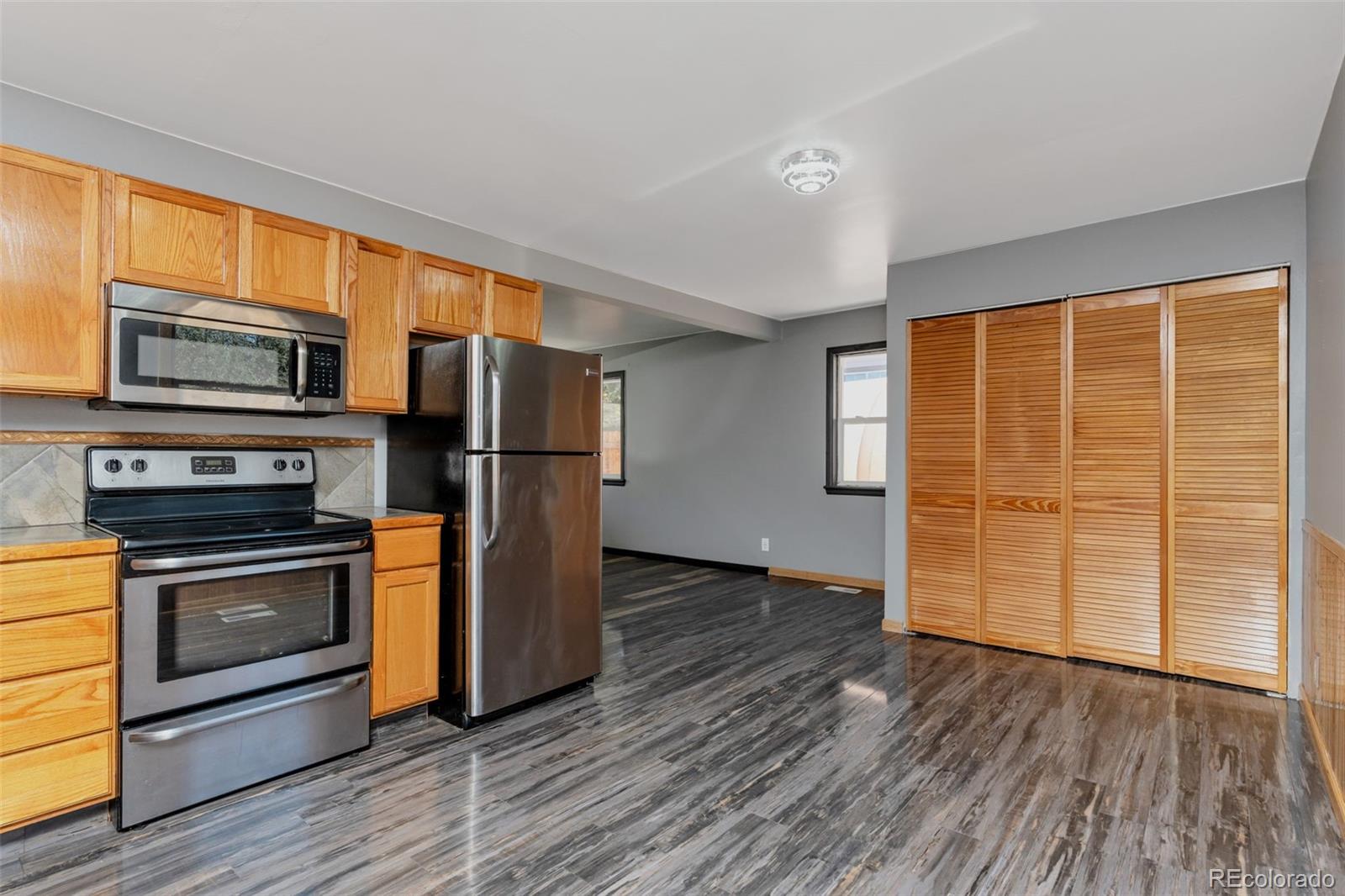 1781 Rowena Street Thornton, CO 80229 - Photo 15 of 21 a kitchen with stainless steel appliances a stove and a refrigerator