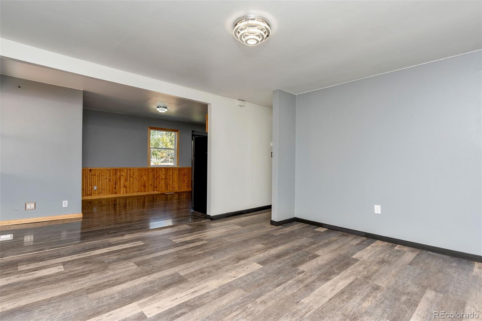 1781 Rowena Street Thornton, CO 80229 - Photo 4 of 21 a view of a livingroom with wooden floor and window