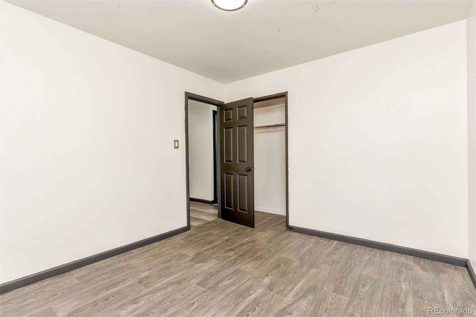 1781 Rowena Street Thornton, CO 80229 - Photo 9 of 21 a view of hallway with wooden floor