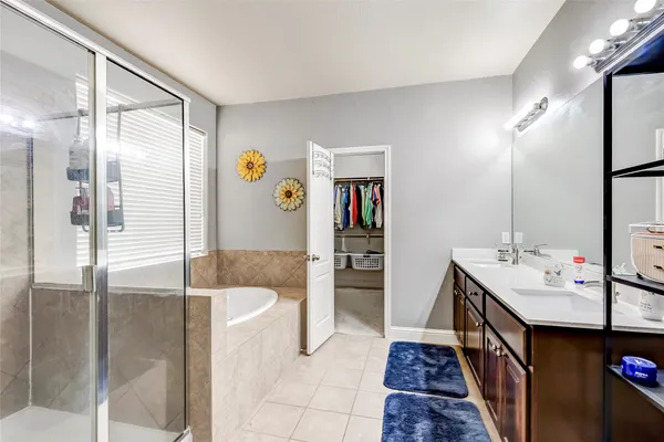 a bathroom with a tub sink and mirror