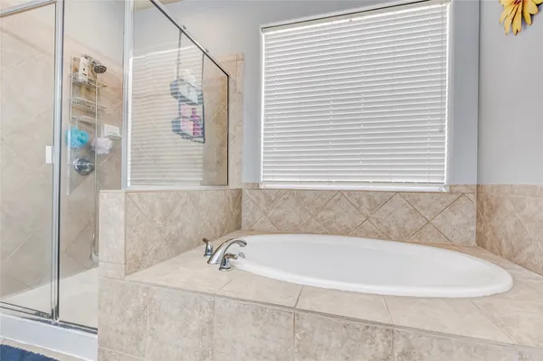 a white bath tub sitting next to a white sink