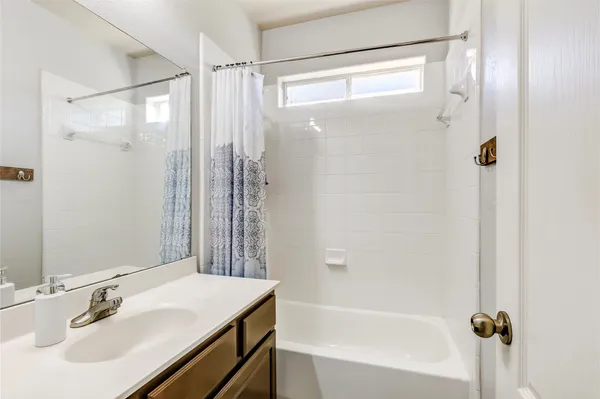 a bathroom with a sink mirror toilet and bathtub