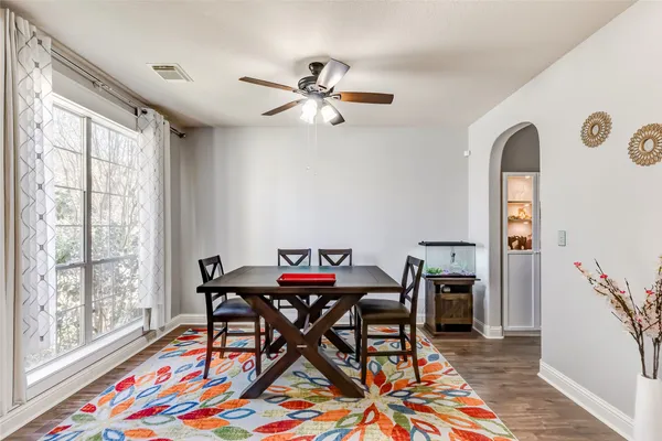 a dining room with furniture and a window