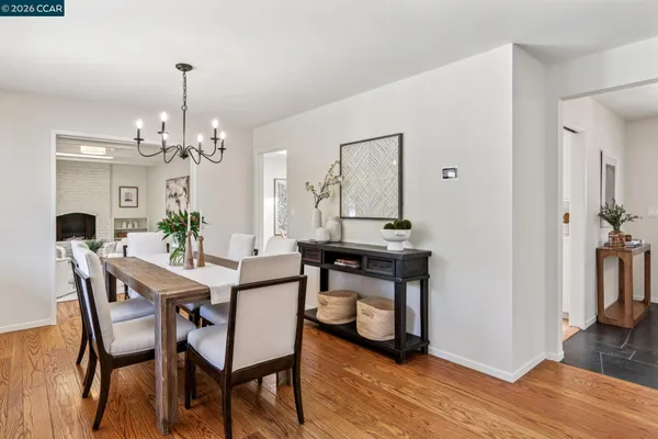 a kitchen with a wooden floor and white appliances