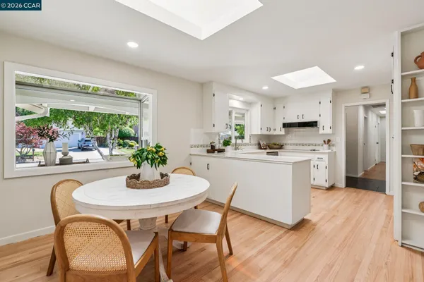 a dining room with furniture and wooden floor