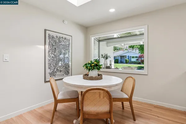 a living room with fireplace furniture and a potted plant