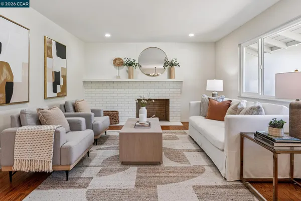 a living room with furniture and a fireplace