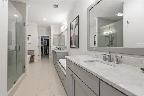 a bathroom with a sink a mirror and a shower