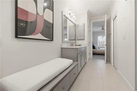 a en suite bathroom with a granite countertop sink mirror and toilet