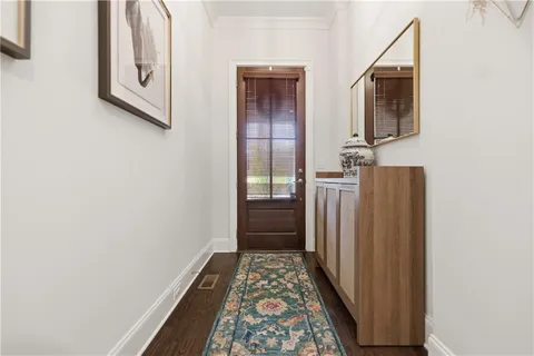 a bathroom with a granite countertop toilet sink and mirror