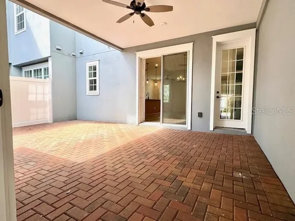a view of a livingroom with wooden floor and a ceiling fan