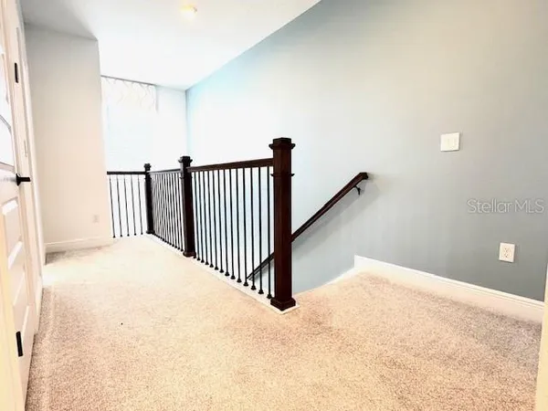 a view of a hallway with staircase
